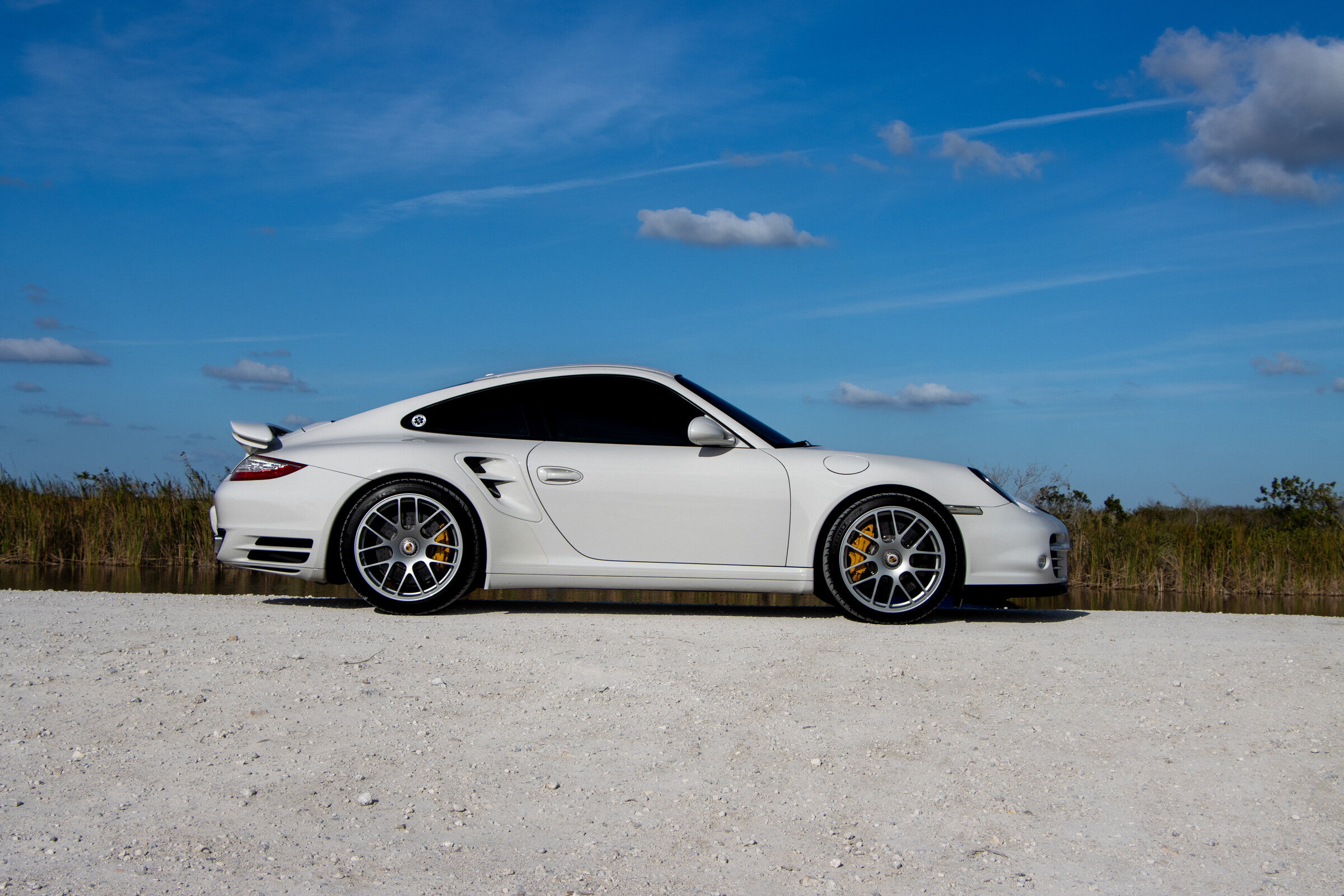 Ian's white Porsche 997.2 Turbo S on the Florida marshland — Porsche Hangout